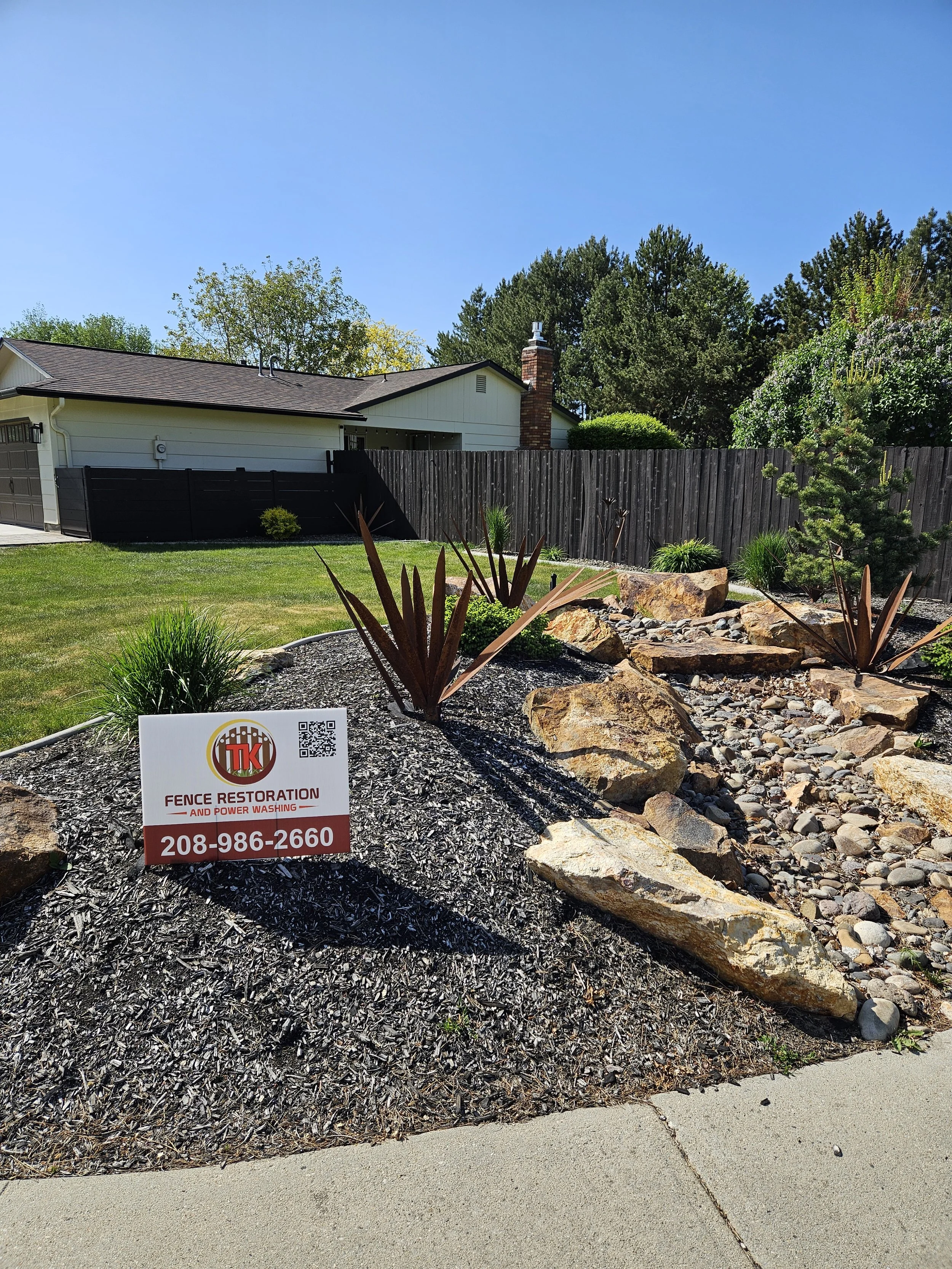 A TK Fence Restoration yard sign on a finished Boise project